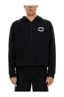 Moschino men’s black zip-up hoodie with white arched embroidered logo on chest in cotton blend material