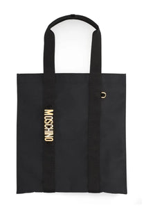 Black moschino women’s carry me tote bag with gold-tone lettering and metallic d-ring accent