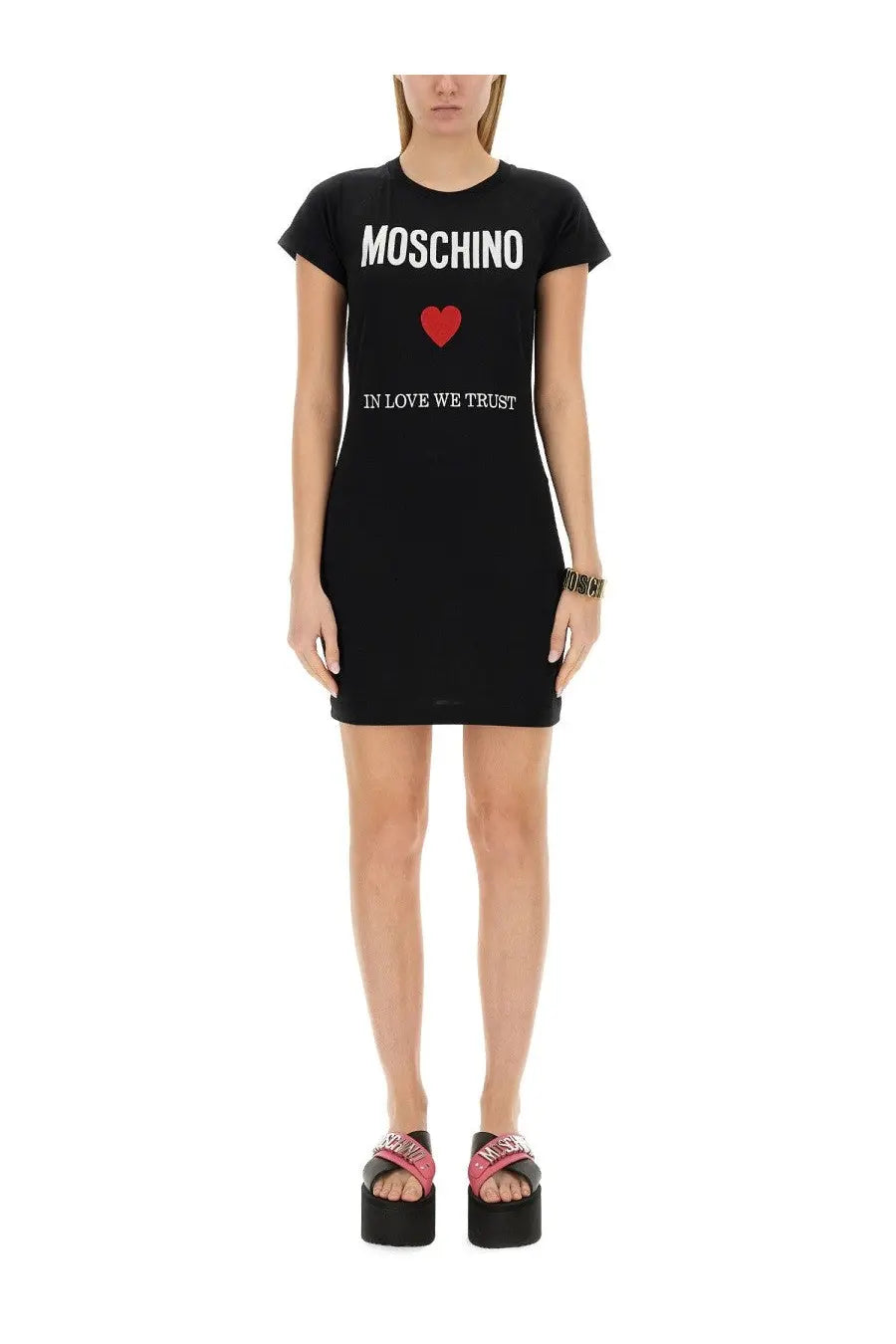 Moschino women’s black t-shirt dress with bold white lettering, red heart emblem, and in love we trust print below