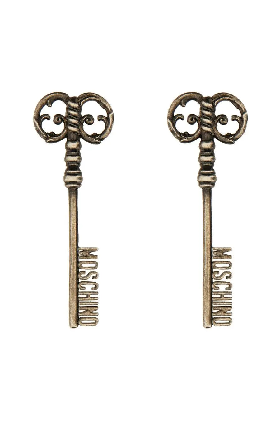 Moschino women’s silver earrings shaped like antique brass-colored keys with intricate scrollwork and logo engraving