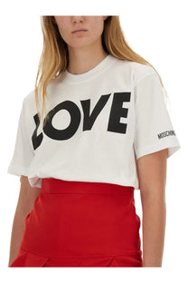 Moschino women’s white cotton t-shirt with bold black love lettering on chest and small logo on sleeve