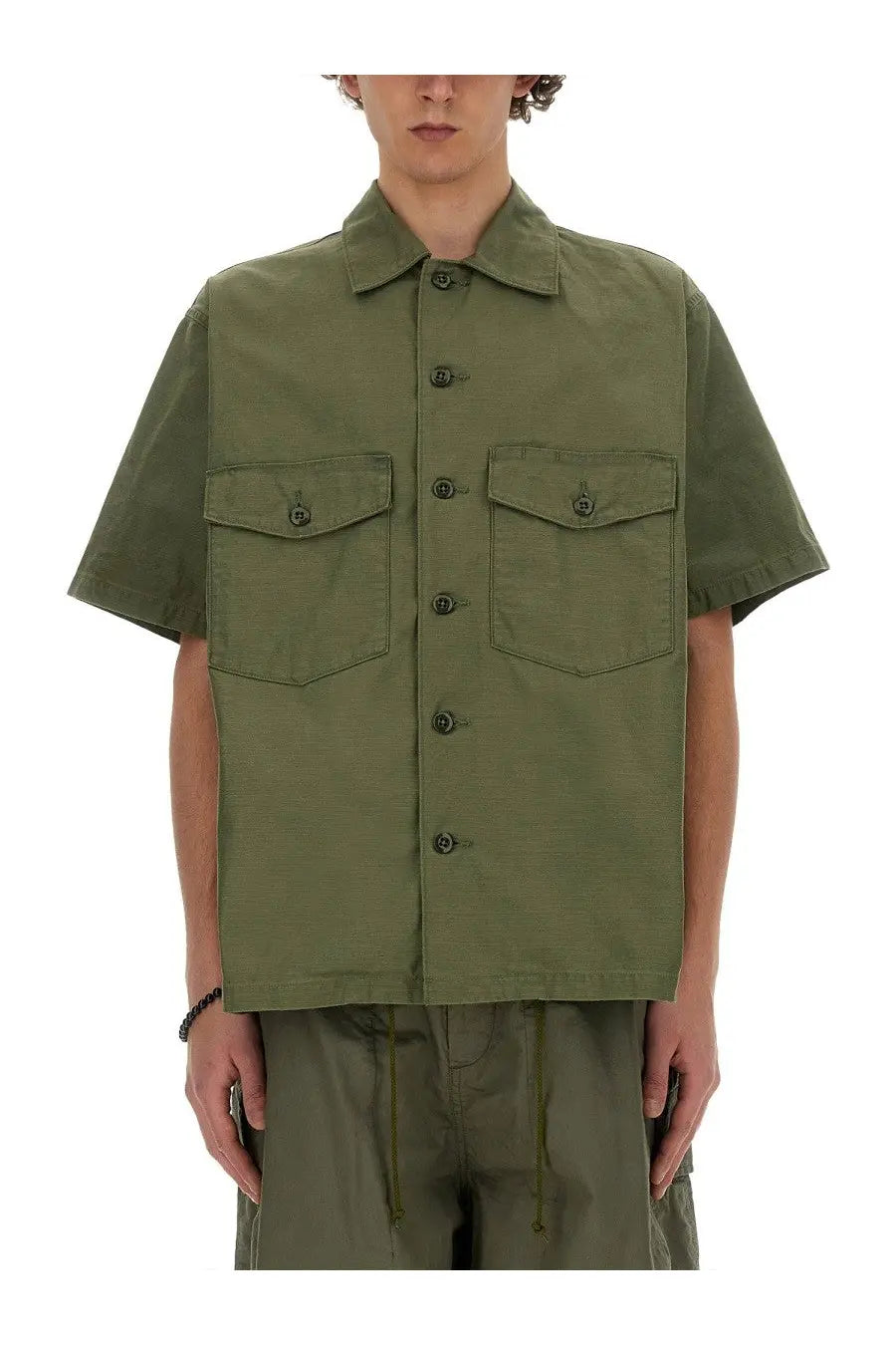 Olive green short-sleeved utility cotton shirt for men with two flap pockets and dark buttons by needles