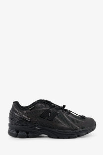 New Balance men’s Gore Tex black 1906r running shoe with mesh and synthetic overlays and subtle gray stitching