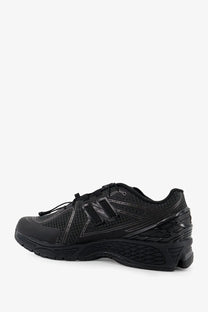New Balance men’s Gore Tex sneakers black with mesh and synthetic overlays featuring subtle reflective accents