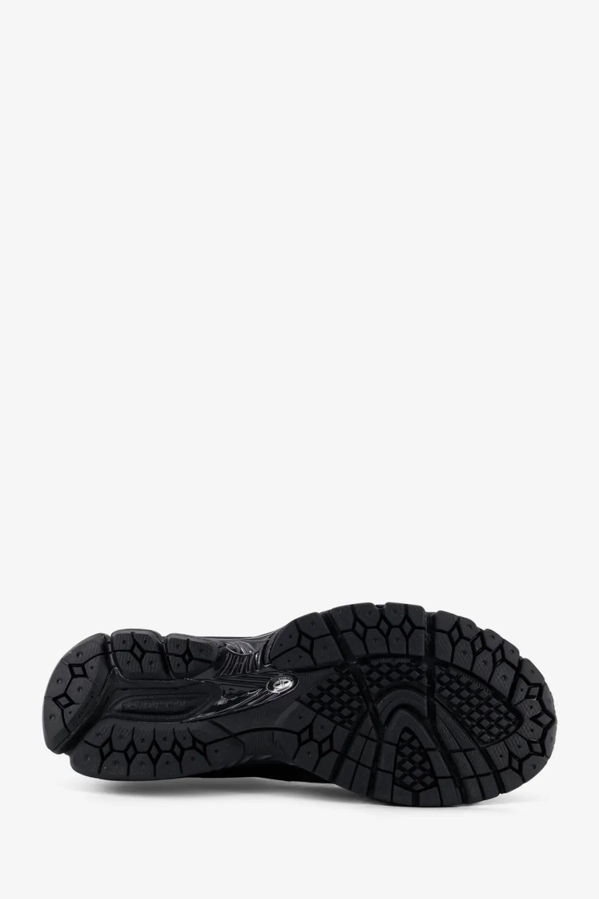 Black rubber sole of new balance men’s gore tex sneakers featuring textured geometric tread and subtle branding details