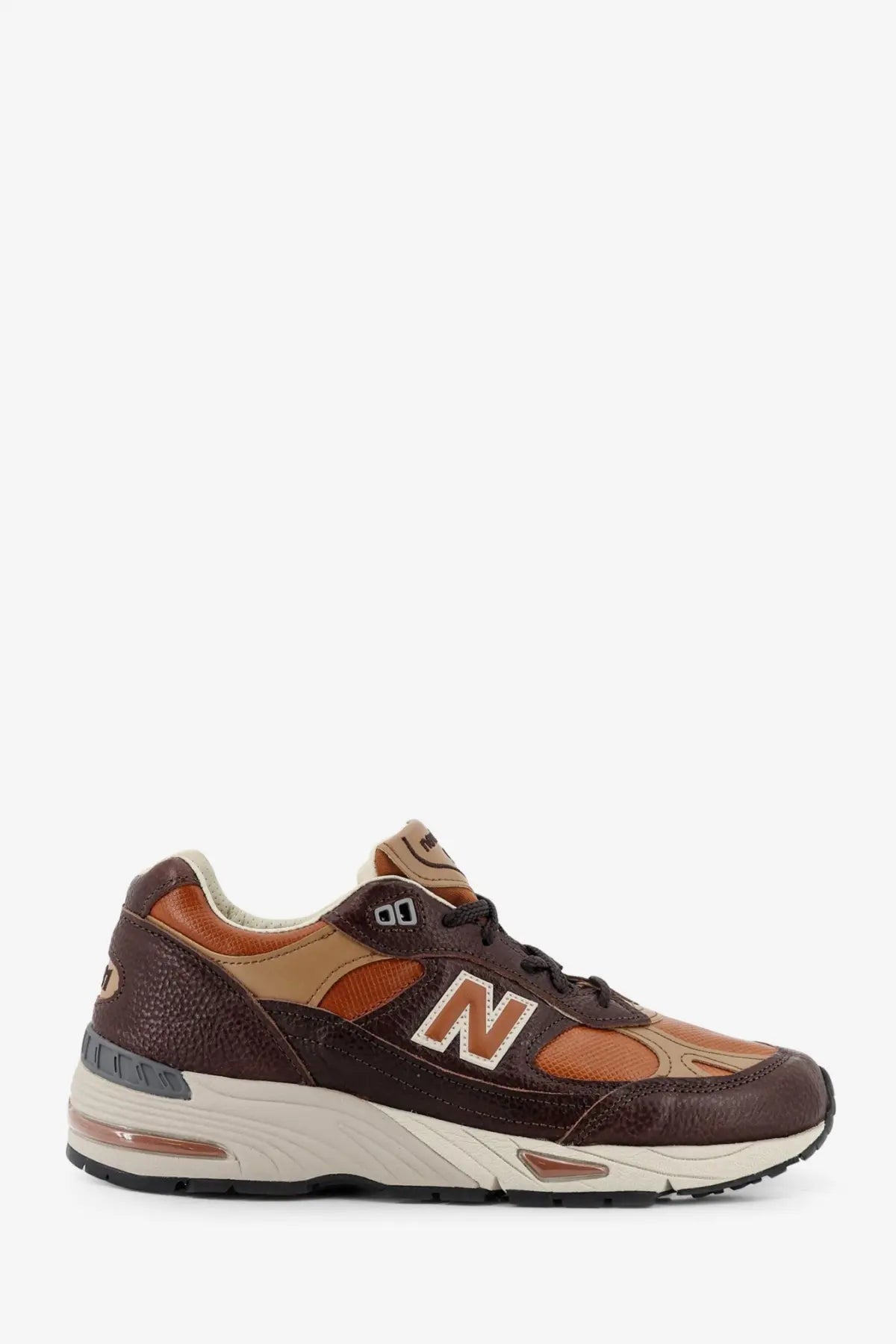 New balance men’s brown leather sneakers with tan mesh panels and visible air cushioning in the sole