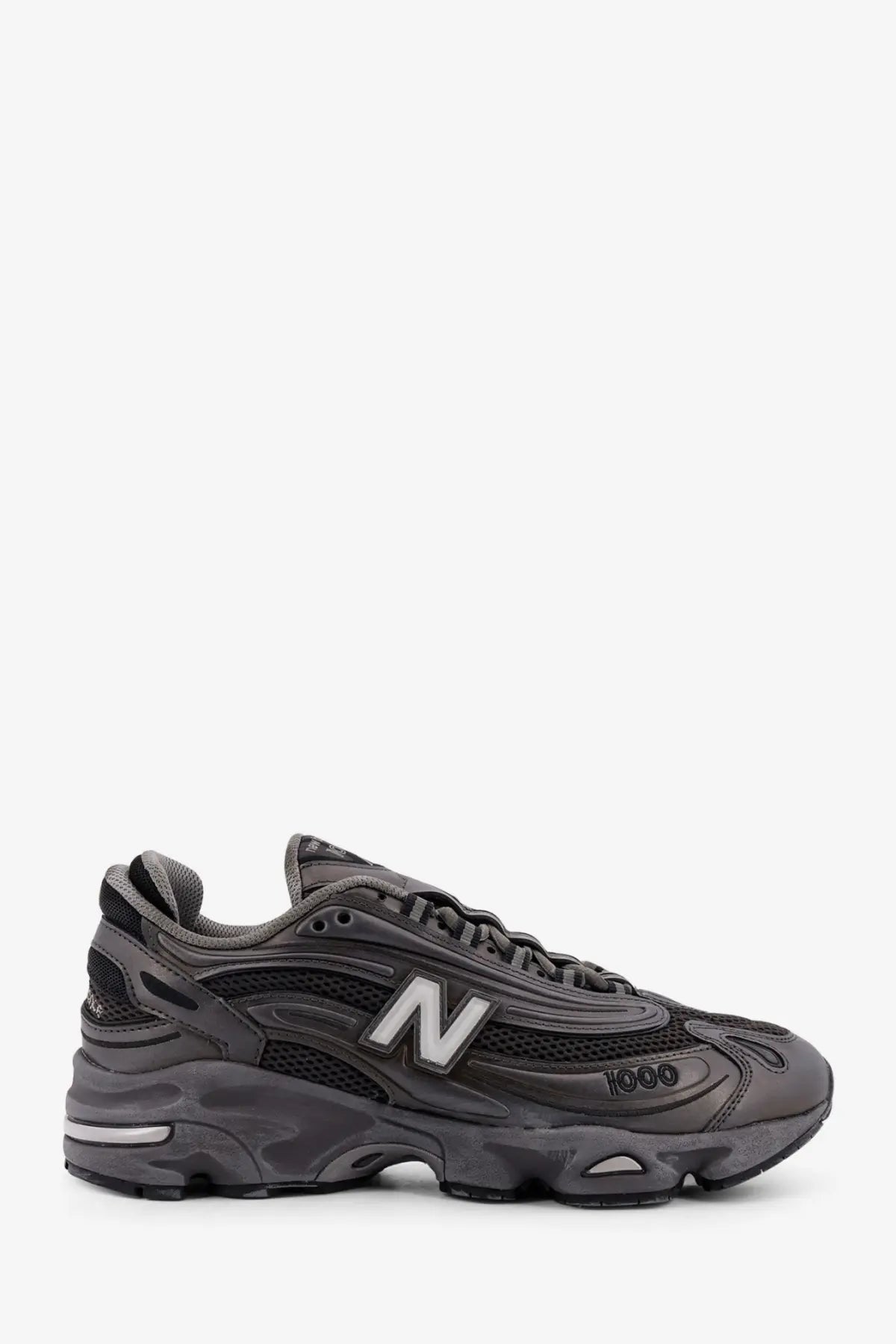 New Balance men’s low top mesh sneaker in dark gray with a chunky layered sole and breathable mesh upper