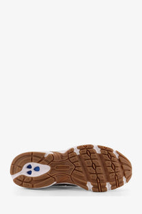 New balance men’s grey mesh low top sneakers with brown and white rubber sole and beige midsole with blue accents