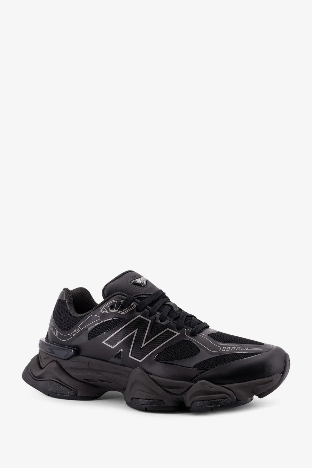 New Balance men’s mesh sneakers black featuring chunky textured sole and subtle silver logo detailing