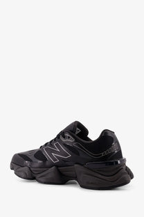 New balance men’s mesh sneaker in black with chunky sole and silver logo accents for casual wear