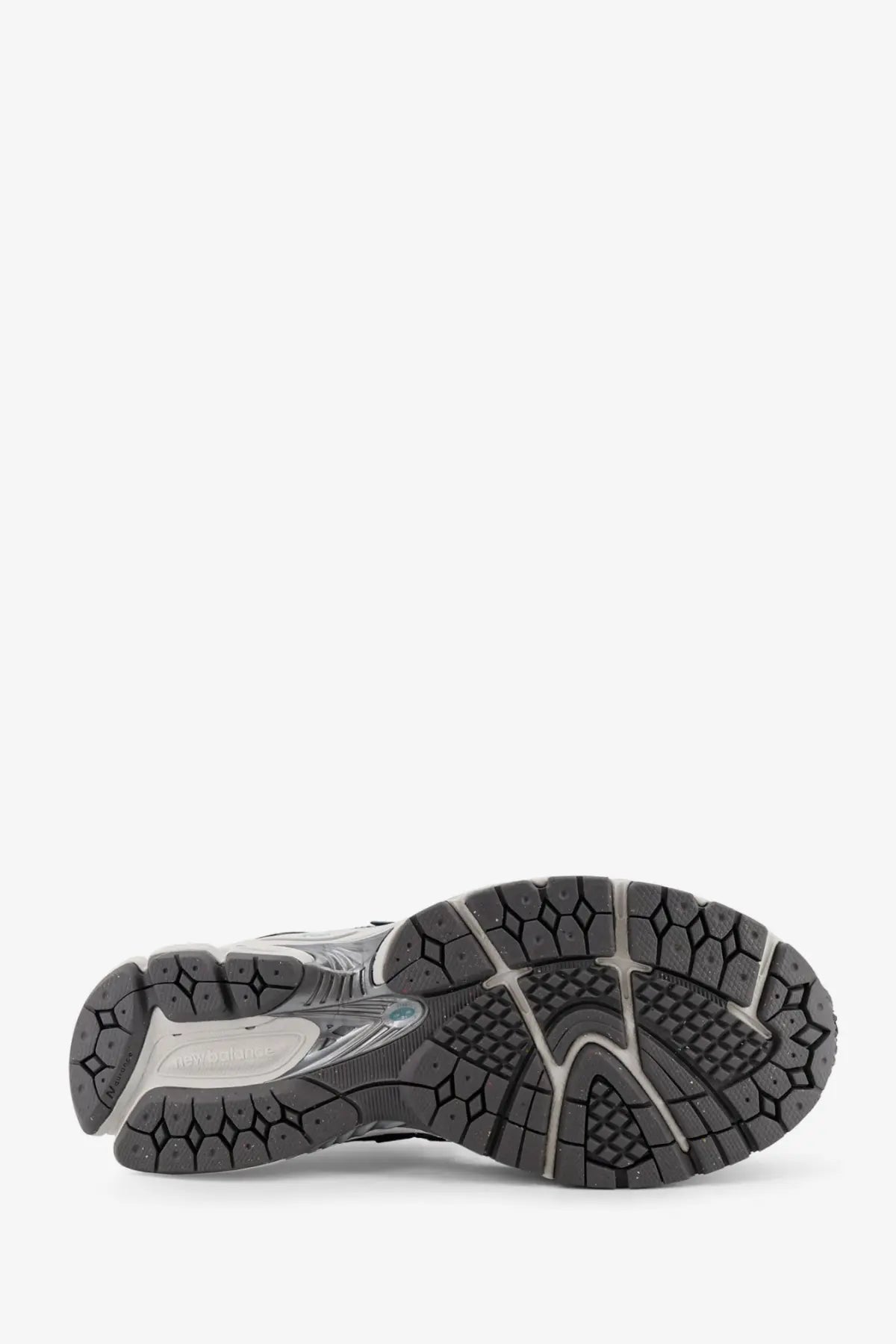 Black and gray rubber sole with textured geometric tread on new balance men’s blue mesh sneakers