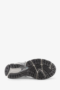 Black and gray rubber sole with textured geometric tread on new balance men’s blue mesh sneakers
