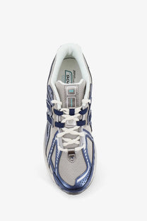 New Balance men’s mesh sneakers blue featuring gray and navy 1006 running shoe with mesh upper metallic accents and white laces