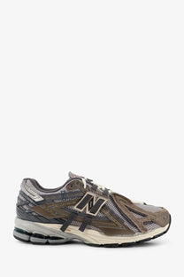 New balance men’s mesh sneakers in brown featuring muted gray brown and beige mesh and suede materials