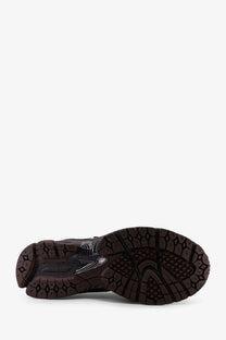 Black rubber sole with textured geometric tread and translucent accents on new balance men’s grey mesh sneakers