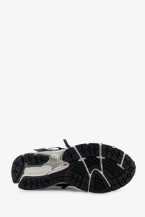 New balance men’s mesh sneakers in black and silver with textured rubber outsole for running and casual wear