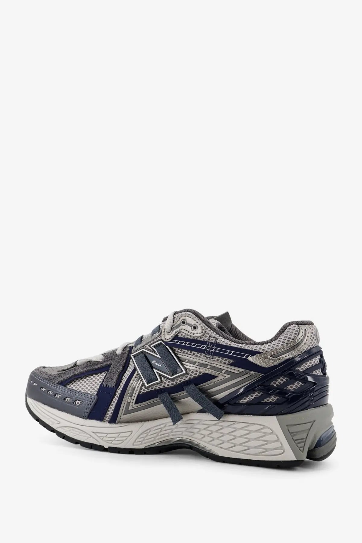 New balance men’s mesh sneakers in grey featuring gray and navy blue running shoe with mesh and synthetic overlays