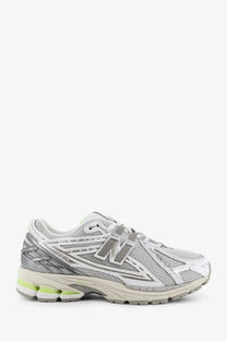 New Balance men’s mesh sneakers grey with silver and white upper, gray branding, and lime green midsole