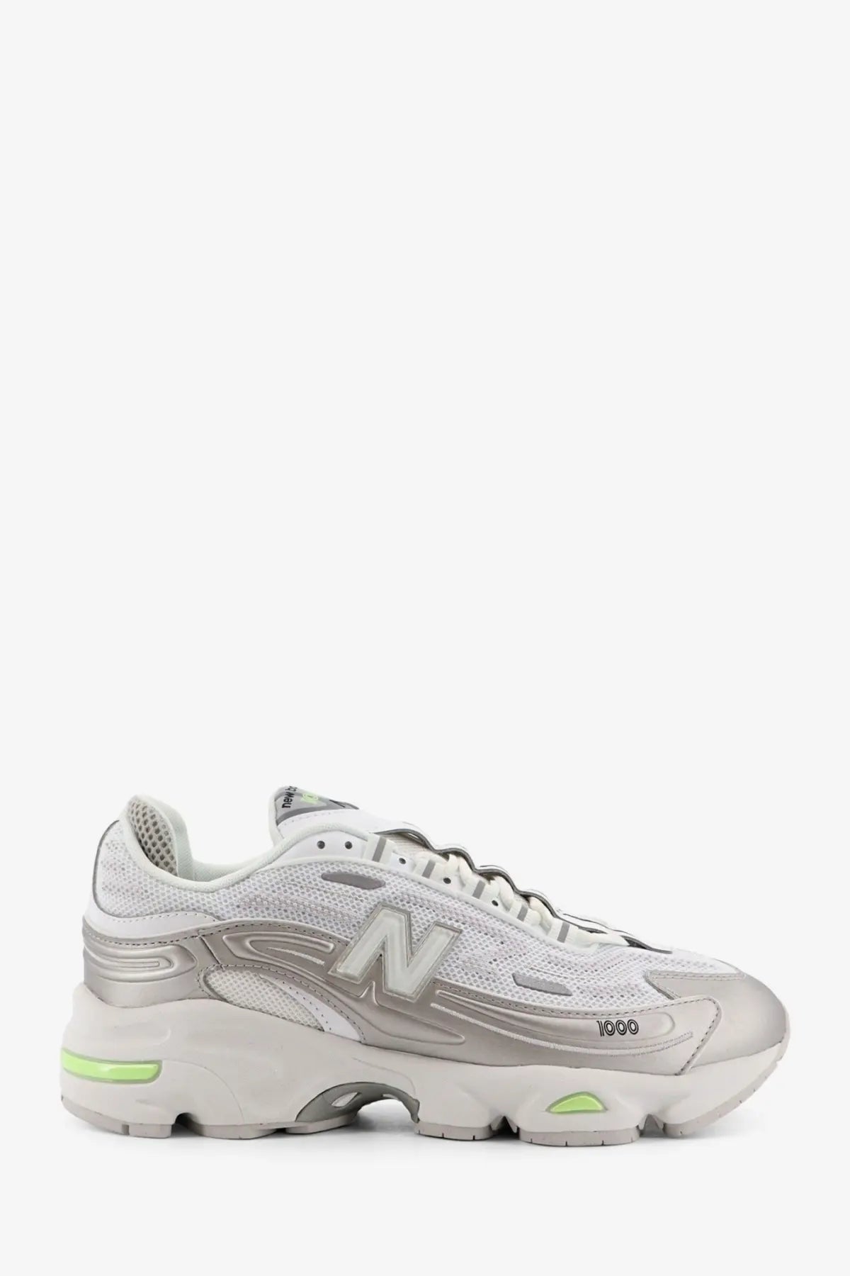 New Balance men’s mesh sneakers white featuring silver and white design with neon green accents on the midsole