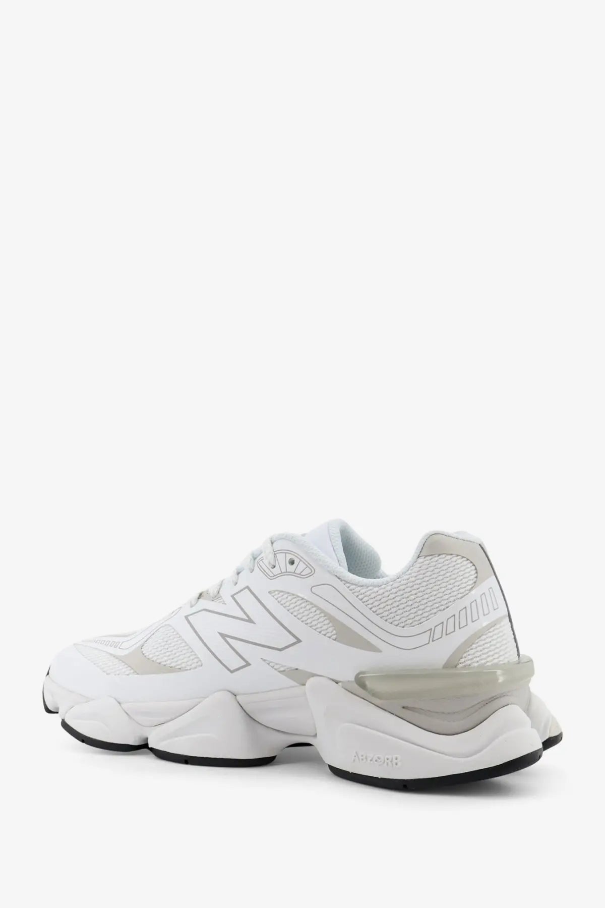 New Balance Men’s white mesh sneaker with chunky layered sole and subtle gray accents for casual wear