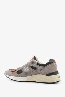 New Balance men’s suede and mesh sneaker in grey with peach accents and cream midsole, model 990v3