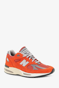 New Balance men’s suede sneakers in vibrant orange with gray mesh and suede accents white midsole and black outsole