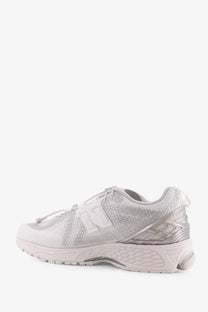 Silver New Balance men’s sneaker with textured mesh upper and translucent overlays from the technical fabric line