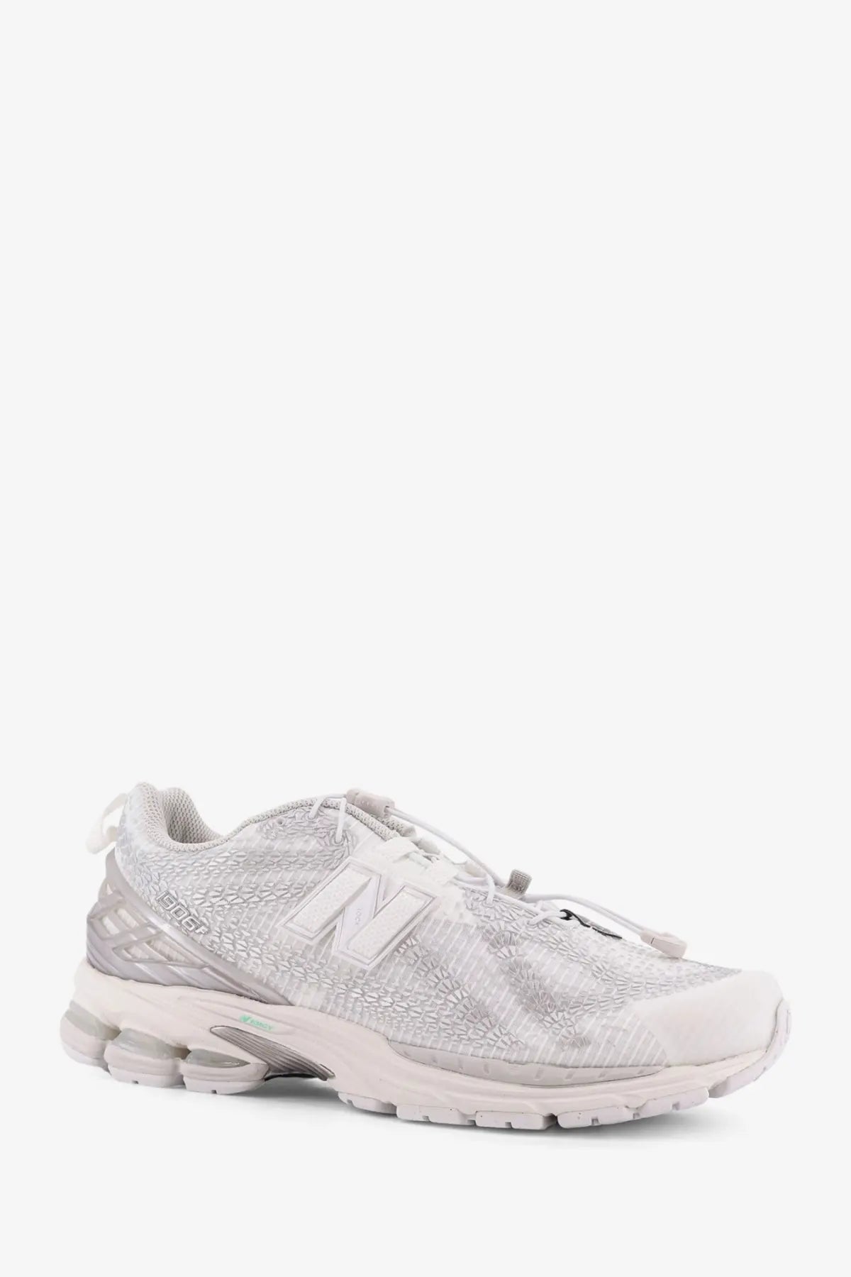 New balance men’s technical fabric sneaker in sleek all-white with textured mesh upper and translucent rubber sole