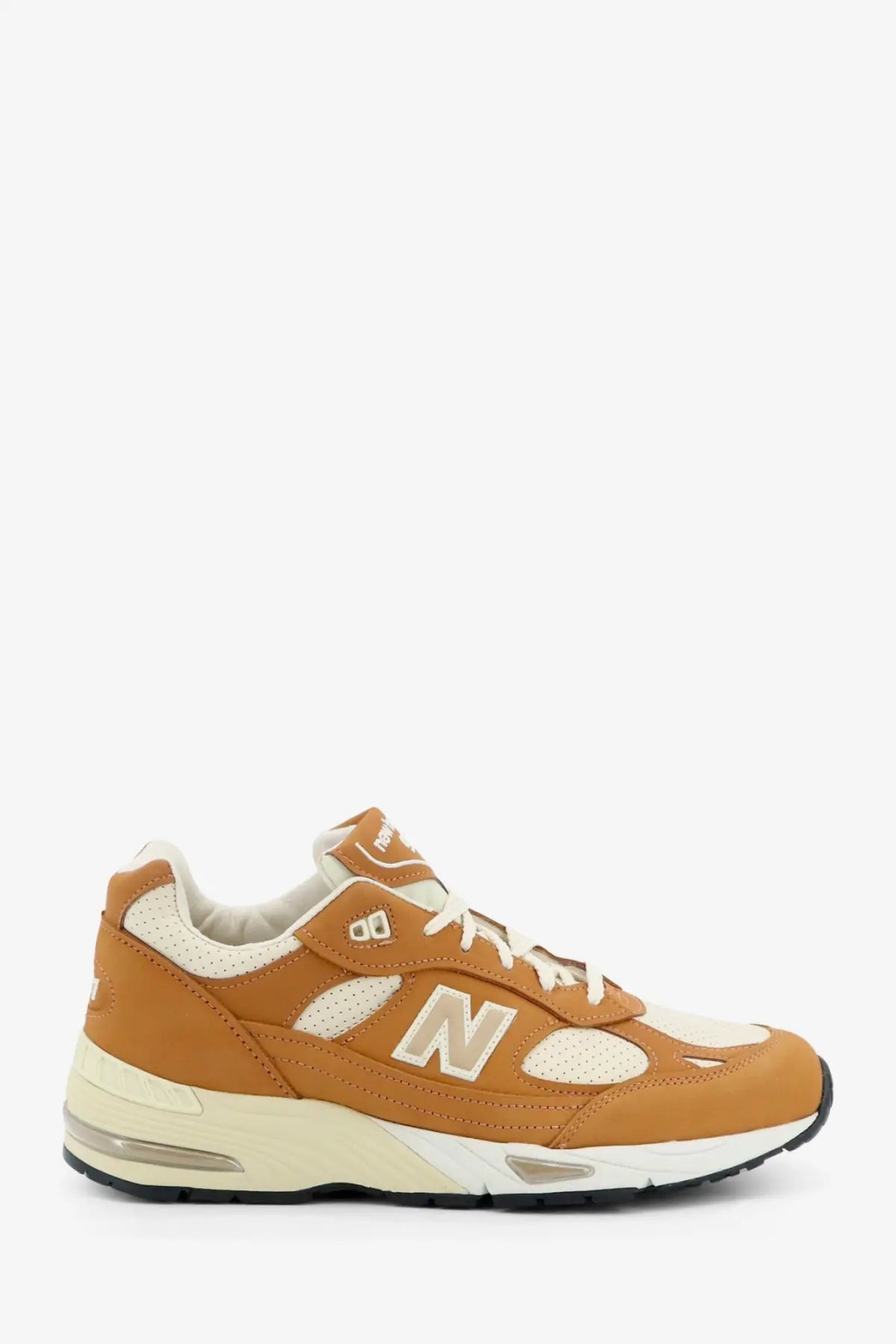 New Balance men’s tier leather sneakers beige featuring tan and cream suede mesh upper with white laces and translucent air unit
