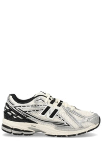 New balance unisex sneaker 1906r in white and black with mesh upper silver accents and cushioned sole for running