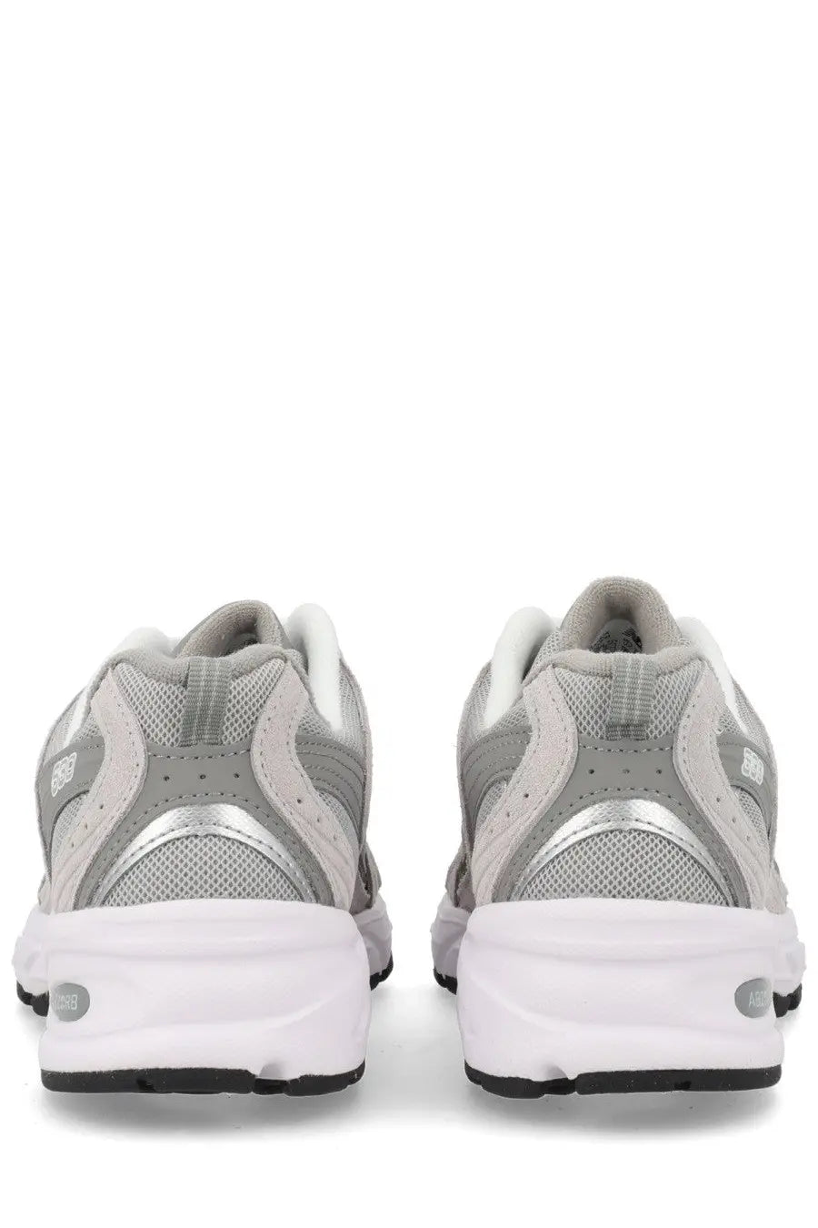 New Balance unisex sneaker grey featuring gray and white mesh and synthetic overlays with silver metallic heel accent
