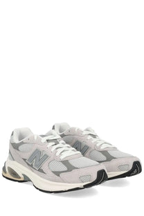 Light gray new balance 920 unisex sneaker with mesh suede upper white laces black outsole and translucent air heel unit