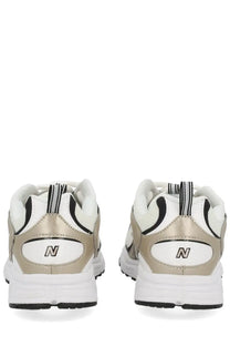 New balance unisex sneaker in white and metallic gold with black accents featuring breathable materials and stylish design