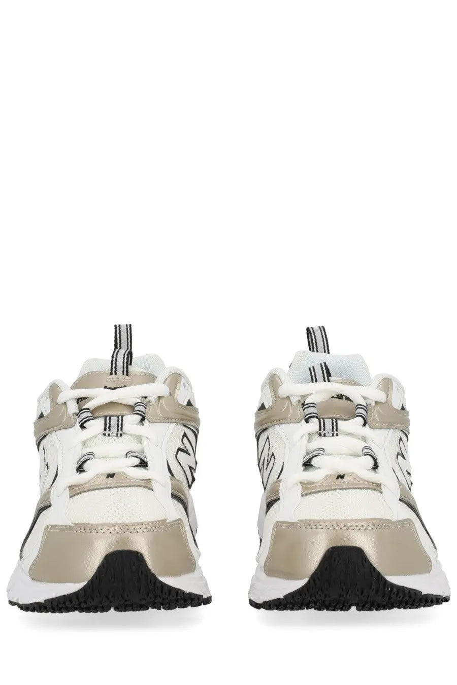 New Balance unisex sneaker in white and metallic gold with black accents and chunky sole design