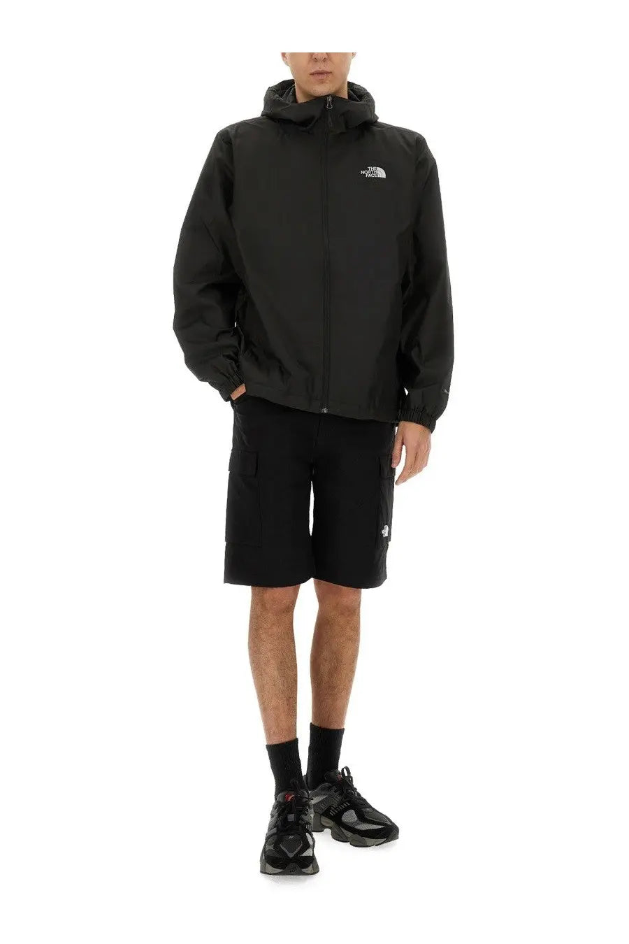 Black the north face men’s cargo shorts paired with a black hooded jacket featuring a subtle white logo on the chest