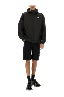 Black the north face men’s cargo shorts paired with a black hooded jacket featuring a subtle white logo on the chest