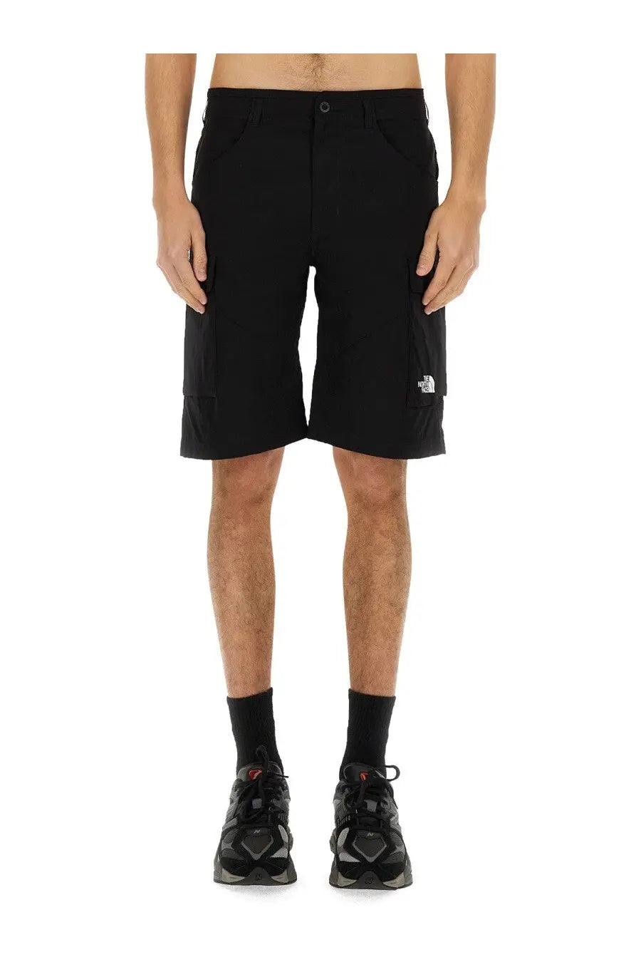 The north face men’s black cargo shorts made from durable fabric with a subtle white logo on the lower leg