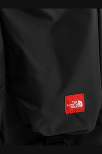 The North Face men’s black nylon handbag with textured fabric and a red logo patch on the front side