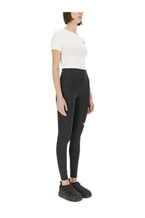 Black high-waisted leggings with subtle logo on thigh and hip paired with the north face women’s cropped shirt white