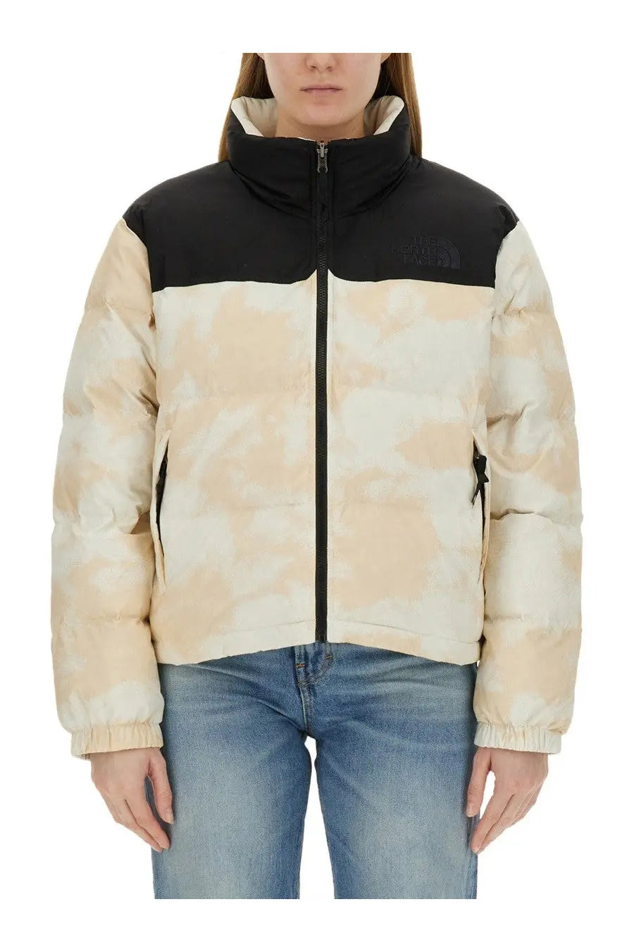 The north face women’s down jacket in beige and black camouflage with high collar and front zipper closure