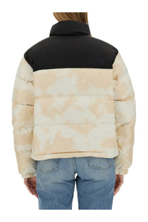 The north face women’s down jacket features a beige and black puffer design with a camouflage pattern on the body