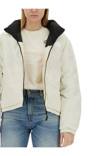 The North Face women’s down jacket multicolor cream puffer with black hood zipper accents and logo on the chest