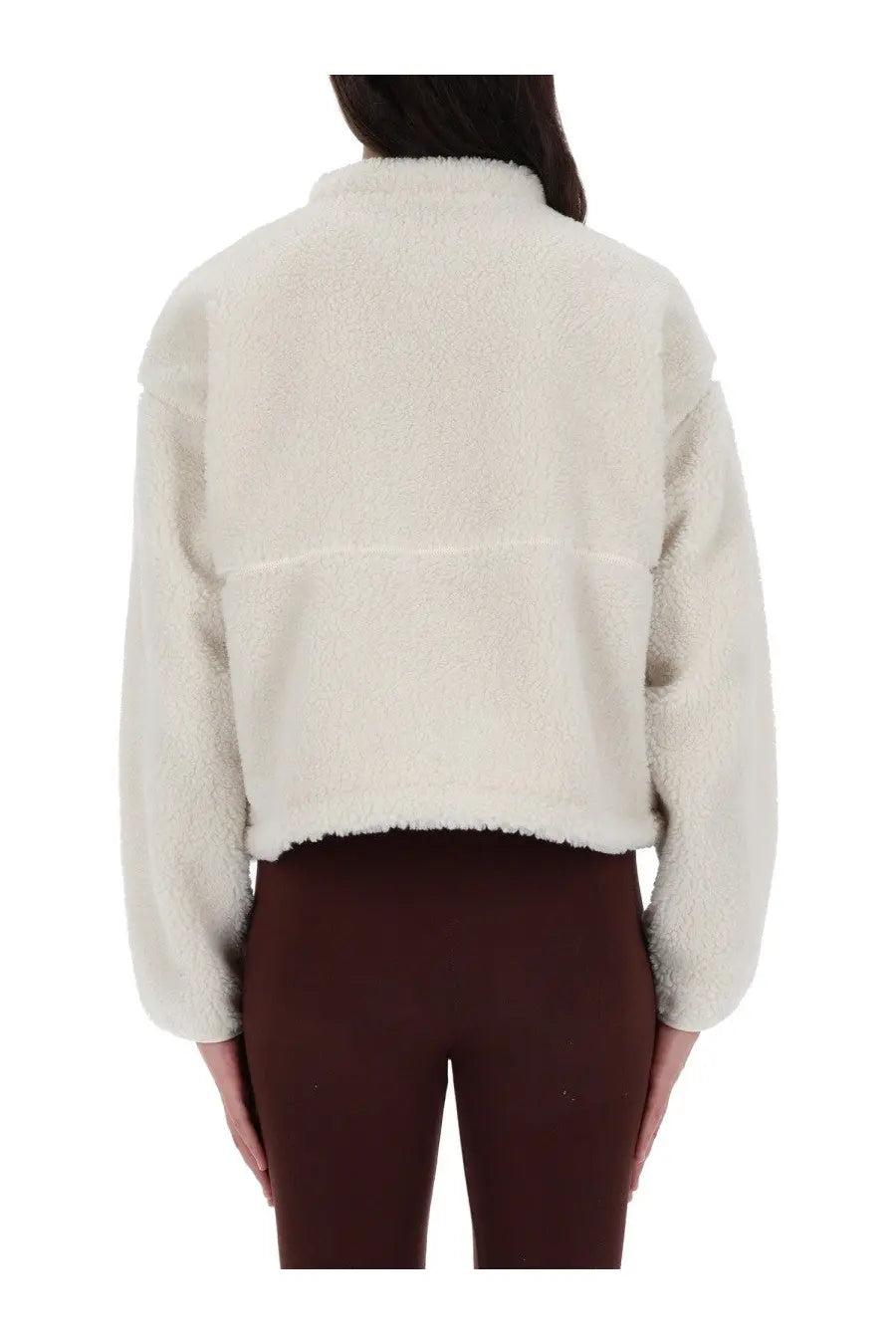 The North Face women’s extreme jacket is a cream-colored plush faux fur cropped jacket with a high collar and relaxed fit