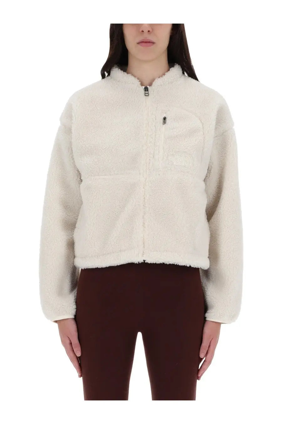 The North Face women’s extreme jacket white is a cream-colored plush fleece jacket with a front zipper and chest pocket