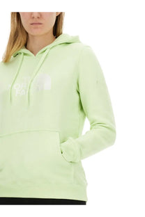 The north face women’s sweatshirt green is a soft mint green hoodie featuring a white logo and matching drawstrings