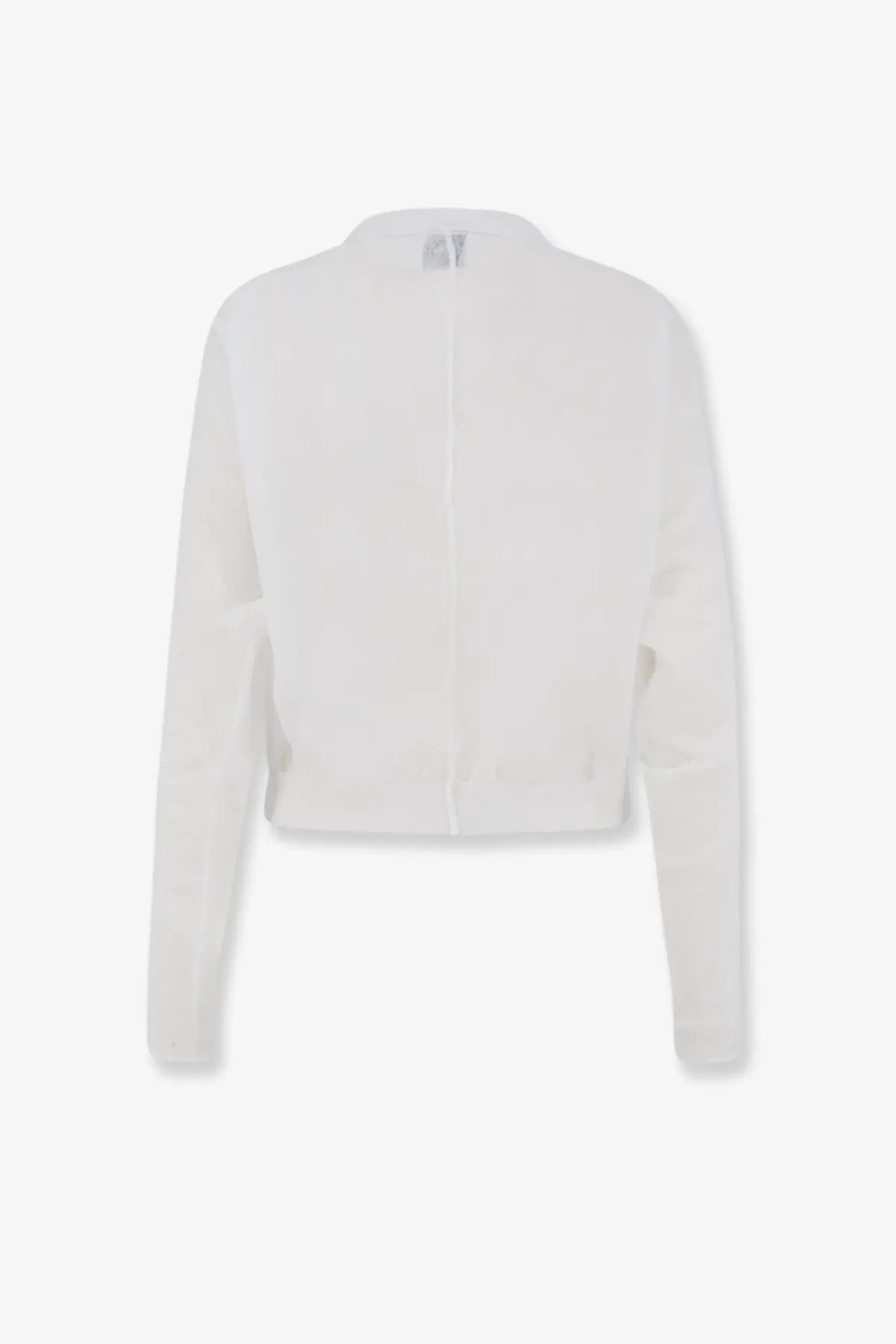 White cropped knit cardigan with long sleeves and central zipper paired with nude women’s cotton blend polo shirt white