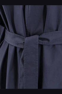 Dark navy belted cotton coat with matching fabric belt tied in a neat knot for women’s outerwear