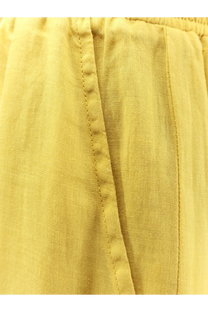 Nude women’s linen blend trousers cedar shown from the back with relaxed yellow linen pants featuring visible stitching