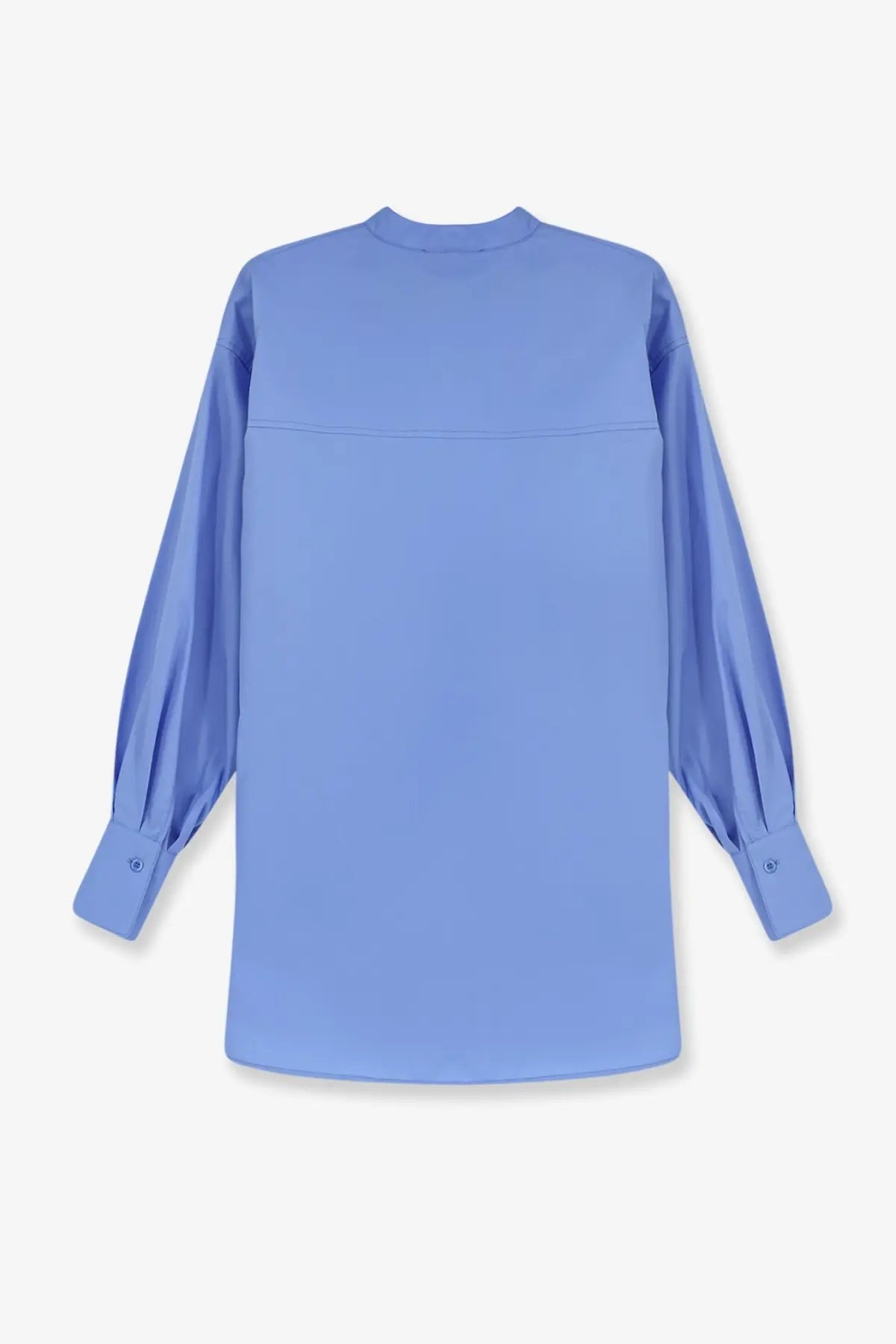 Nude women’s oversize cotton shirt in light blue with long sleeves and a subtle seam across the chest