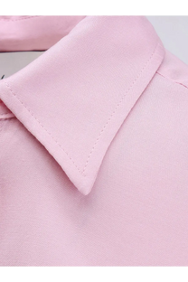 A soft pink collar of a nude womens viscose shirt made from smooth woven fabric with neat stitching